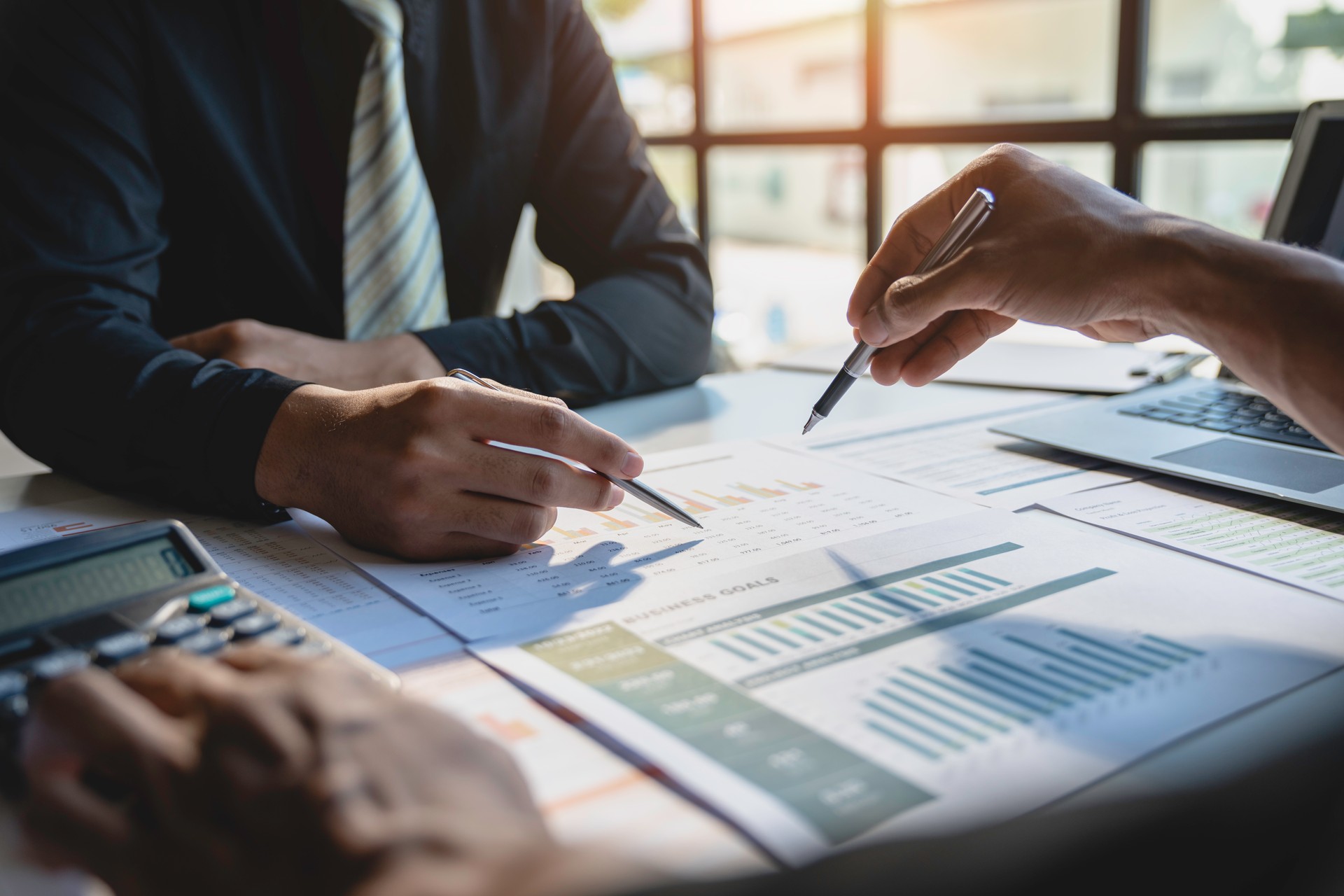 Teamwork with business people analysis cost graph on the desk in the meeting room. The business team discussed meetings and briefing strategies. Negotiation, Analysis, Discussion